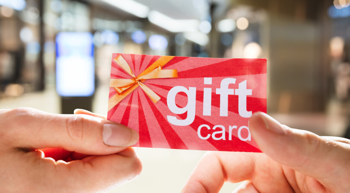Someone giving gift card to another person